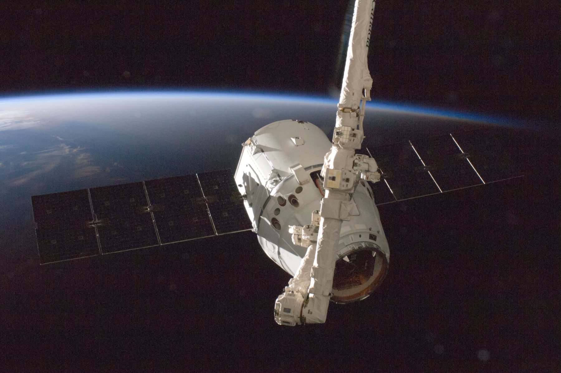 Cargo spacecraft berthing above Earth