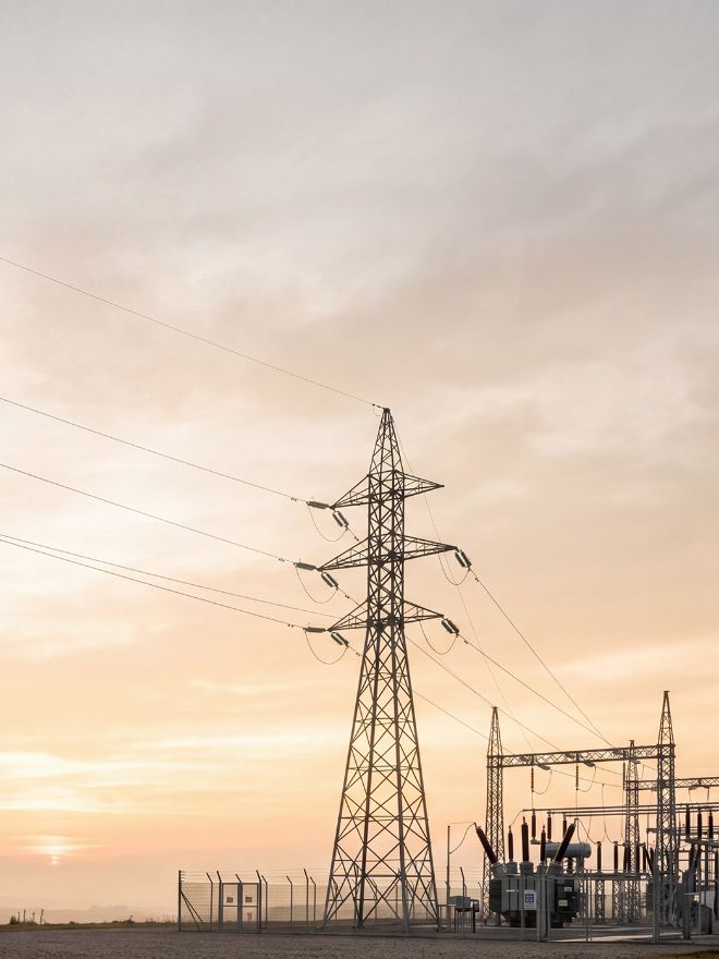 Transmission tower and substation at sunset