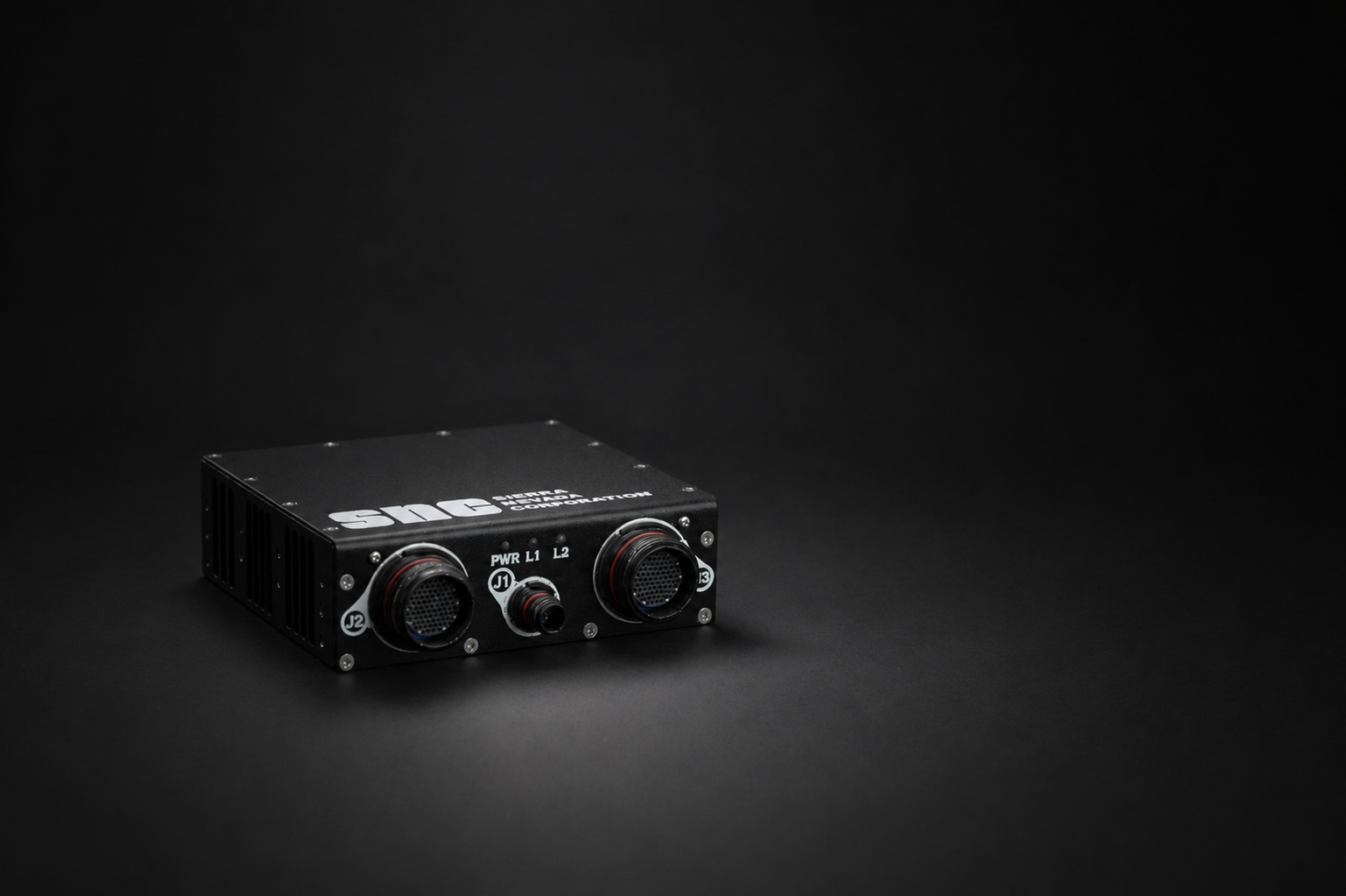 SNC avionics guard unit on a dark studio background